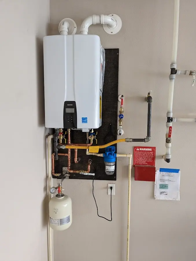 Professional plumber installing copper piping in a Cochran home